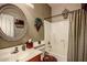 Compact bathroom with vanity, round mirror, and shower-tub combination at 4083 E Rustler Way, Gilbert, AZ 85297