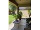 Inviting covered patio with potted plants, a unique stone table, and comfortable seating, perfect for outdoor relaxation at 4083 E Rustler Way, Gilbert, AZ 85297