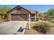 A well-maintained home with a two-car garage and desert landscaping at 4083 E Rustler Way, Gilbert, AZ 85297