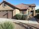 Charming home with well-manicured landscaping, a tile roof, and a two-car garage at 4083 E Rustler Way, Gilbert, AZ 85297