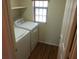 A functional laundry room equipped with a washer, dryer, window, and overhead storage shelf at 4083 E Rustler Way, Gilbert, AZ 85297