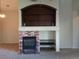 Cozy living room featuring a brick fireplace with built-in shelves and modern design elements at 4083 E Rustler Way, Gilbert, AZ 85297