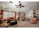 Inviting living room with large windows, comfortable seating, plush carpeting, and soft neutral tones at 4083 E Rustler Way, Gilbert, AZ 85297