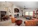 Spacious living room with fireplace, built-ins, comfortable seating, and neutral carpeting at 4083 E Rustler Way, Gilbert, AZ 85297