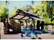 Community playground with climbing wall, swings and picnic pavilion at 4083 E Rustler Way, Gilbert, AZ 85297