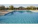 Well-maintained community pool with plenty of room for swimming and relaxing in the sun at 4083 E Rustler Way, Gilbert, AZ 85297