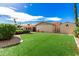 Expansive backyard features lush artificial turf, a covered patio, and well-maintained landscaping at 410 E Beck Ln, Phoenix, AZ 85022