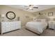 Bright bedroom with neutral tones, featuring a queen-sized bed, dresser, and serene decor for a restful retreat at 410 E Beck Ln, Phoenix, AZ 85022