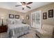 Cozy bedroom with a ceiling fan, shuttered window, and neutral decor at 410 E Beck Ln, Phoenix, AZ 85022