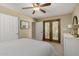 Comfortable bedroom with French doors, featuring a cozy bed and ample natural light for a peaceful ambiance at 410 E Beck Ln, Phoenix, AZ 85022