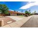 Spacious driveway leading to a two-car garage, with desert landscaping and a well-kept lawn at 410 E Beck Ln, Phoenix, AZ 85022