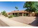 Charming single-story home featuring a tile roof, desert landscaping, and an inviting front porch at 410 E Beck Ln, Phoenix, AZ 85022