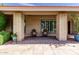Inviting front porch with brick columns, cozy seating, and well-manicured greenery at 410 E Beck Ln, Phoenix, AZ 85022
