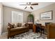 Cozy home office featuring a comfortable sofa, wooden desk, and decorative accents for a productive and stylish workspace at 410 E Beck Ln, Phoenix, AZ 85022