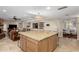 Open kitchen with center island, tile floor and neutral color palette is great for entertaining at 410 E Beck Ln, Phoenix, AZ 85022