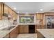 Updated kitchen with stainless steel appliances, tile backsplash, and a view of the backyard pool at 410 E Beck Ln, Phoenix, AZ 85022