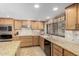 Well-lit kitchen featuring tile backsplash, stainless steel appliances and a window overlooking the pool area at 410 E Beck Ln, Phoenix, AZ 85022