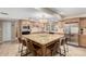 Kitchen features a large center island with granite countertop, stainless steel appliances, and tile backsplash at 410 E Beck Ln, Phoenix, AZ 85022