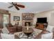 Inviting living room featuring a brick fireplace, leather seating, and a television at 410 E Beck Ln, Phoenix, AZ 85022