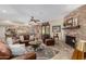 Open-concept living room with a brick fireplace, comfortable seating, and seamless flow to the kitchen at 410 E Beck Ln, Phoenix, AZ 85022