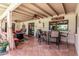 Inviting covered patio with comfortable seating, a bar area, and ceiling fans for outdoor relaxation and entertaining at 410 E Beck Ln, Phoenix, AZ 85022