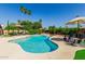 Beautiful pool area with a freeform pool, mature landscaping, and comfortable seating for outdoor relaxation at 410 E Beck Ln, Phoenix, AZ 85022