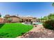 Backyard showcasing the pool, patio furniture, and lush, well-maintained lawn, perfect for outdoor living at 410 E Beck Ln, Phoenix, AZ 85022