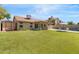 Spacious backyard with lush green grass, covered patio, shed and a fenced in pool area at 4213 W Calle Lejos --, Glendale, AZ 85310
