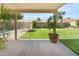 Covered patio overlooking a green backyard and fenced pool area at 4213 W Calle Lejos --, Glendale, AZ 85310