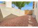 Backyard features desert landscaping, block fence, and stone path at 4213 W Calle Lejos --, Glendale, AZ 85310