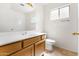 Bright bathroom featuring tiled floors, a single sink vanity, and toilet at 4213 W Calle Lejos --, Glendale, AZ 85310