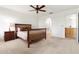 Spacious bedroom with carpet and wooden furniture, featuring a ceiling fan and bathroom access at 4213 W Calle Lejos --, Glendale, AZ 85310