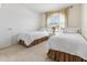 Comfortable bedroom with twin beds, carpet flooring, and a window with blinds and curtains at 4213 W Calle Lejos --, Glendale, AZ 85310