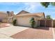 Home exterior featuring a two-car garage, desert landscaping, and a well-manicured lawn at 4213 W Calle Lejos --, Glendale, AZ 85310