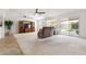 Open living room featuring vaulted ceiling, neutral carpet, and seamless access to outdoor patio at 4213 W Calle Lejos --, Glendale, AZ 85310