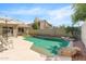 Backyard pool features a rock waterfall and lounge chairs on the pool deck at 4213 W Calle Lejos --, Glendale, AZ 85310