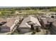 An aerial view showcasing the home's layout, tile roof, landscaping, and the surrounding golf course community at 4316 E Strawberry Dr, Gilbert, AZ 85298
