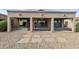 Covered back patio featuring three archways, neutral stucco, and low-maintenance desert landscaping at 4316 E Strawberry Dr, Gilbert, AZ 85298
