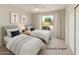 Comfortable bedroom with twin beds, artwork, and a view to the outside at 4316 E Strawberry Dr, Gilbert, AZ 85298