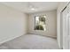 Carpeted bedroom featuring a ceiling fan, closet, neutral paint, and natural light from the window at 4316 E Strawberry Dr, Gilbert, AZ 85298