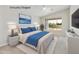 Bright main bedroom features a large window, ceiling fan and neutral tones at 4316 E Strawberry Dr, Gilbert, AZ 85298
