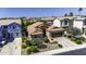 Aerial view of a charming home with desert landscaping, a two-car garage, and mature trees at 43330 W Delia Blvd, Maricopa, AZ 85138