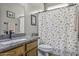 Bathroom with a granite countertop, decorative shower curtain, and ample lighting at 43330 W Delia Blvd, Maricopa, AZ 85138