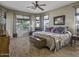 Large bedroom with wood floors, lots of natural light, ceiling fan and comfortable furnishings at 43330 W Delia Blvd, Maricopa, AZ 85138