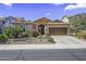 Charming home featuring mature trees, desert landscaping, and a two car garage at 43330 W Delia Blvd, Maricopa, AZ 85138