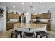 Open kitchen featuring a large island with seating, ample cabinet space, and recessed lighting at 43330 W Delia Blvd, Maricopa, AZ 85138