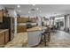 Spacious kitchen with a large island and seating, stainless steel appliances, and an adjacent dining area at 43330 W Delia Blvd, Maricopa, AZ 85138