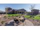 Inviting backyard featuring an outdoor seating area with lush green grass and manicured landscaping at 43712 N Acadia Way, New River, AZ 85087
