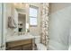 Clean bathroom with tile floors, marble countertop, decorative shower curtain, and sink at 43712 N Acadia Way, New River, AZ 85087