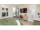 Bedroom with desk, TV, wood floors and view to backyard with outdoor seating at 43712 N Acadia Way, New River, AZ 85087
